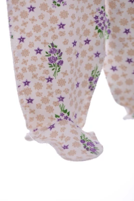 Повзунки трикотажні з бежевим квітами.