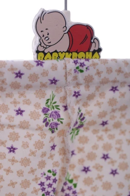 Повзунки трикотажні з бежевим квітами.